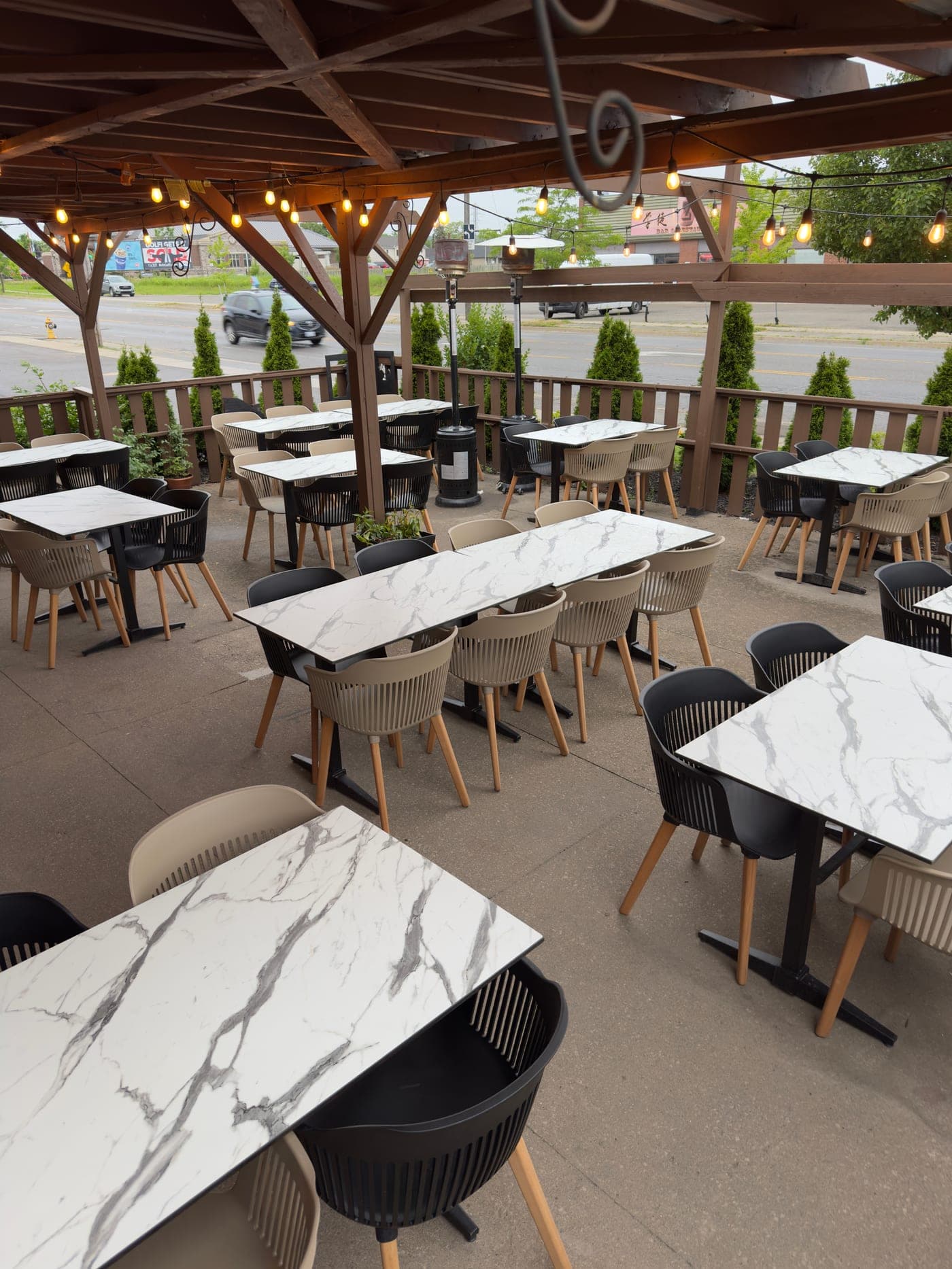 Iskender's covered patio, set with marble tables under string lights